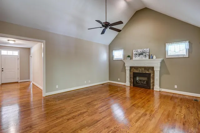 a kitchen with stainless steel appliances granite countertop a sink a refrigerator and a wooden cabinets