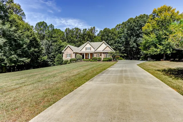 a front view of a house with a yard and trees