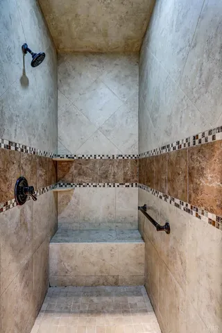 an aerial view of residential house with outdoor space and trees all around