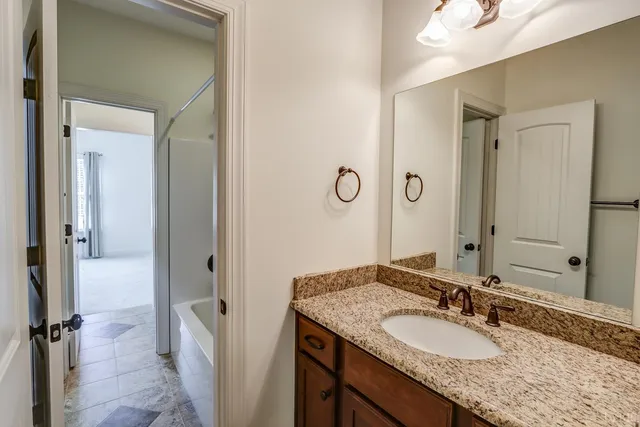 a front view of a house with a yard and trees