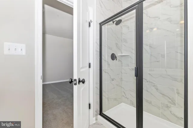 a bathroom with a glass shower door