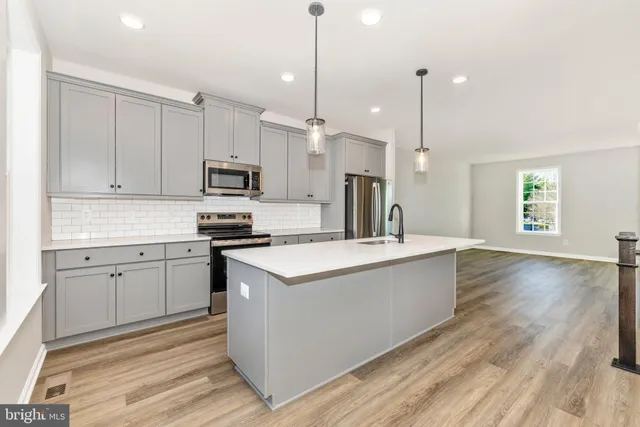 a kitchen with a sink stove and microwave