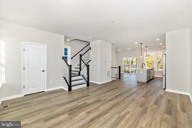 a view of a room with wooden floor and windows