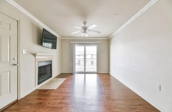 wooden floor fireplace and windows in an empty room