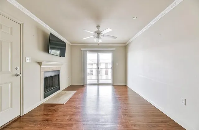 wooden floor fireplace and windows in an empty room
