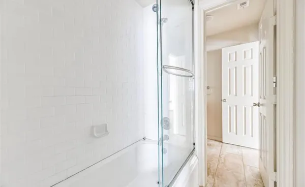 a view of a bathroom from a hallway