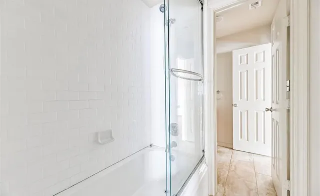 a view of a bathroom from a hallway