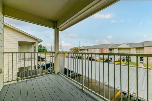 a view of balcony with wooden floor