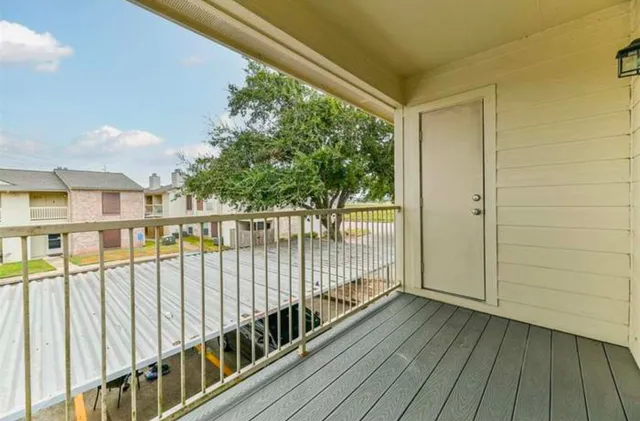 a view of a balcony with wooden floor