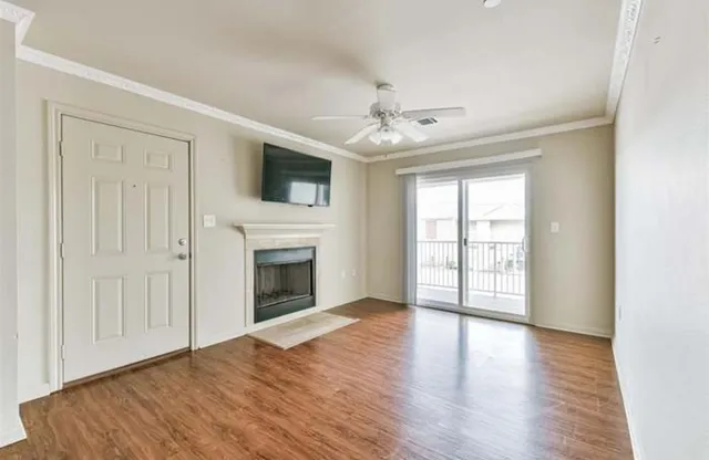wooden floor fireplace and windows in an empty room