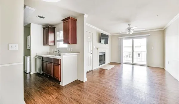 a view of a hallway with wooden floor and a living room