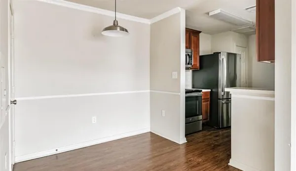 a view of a kitchen with a refrigerator and cabinets