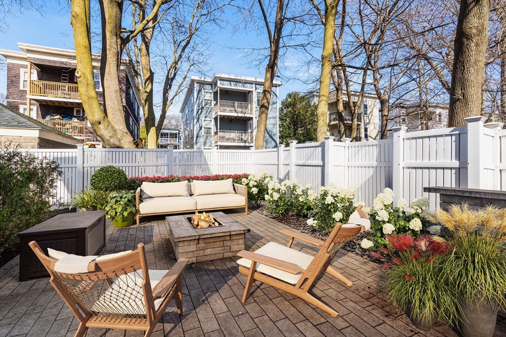 78-80 Rossmore Road, Unit 3 Boston, MA 02130 - Photo 7 of 10 a view of a chairs and table in the backyard of the house