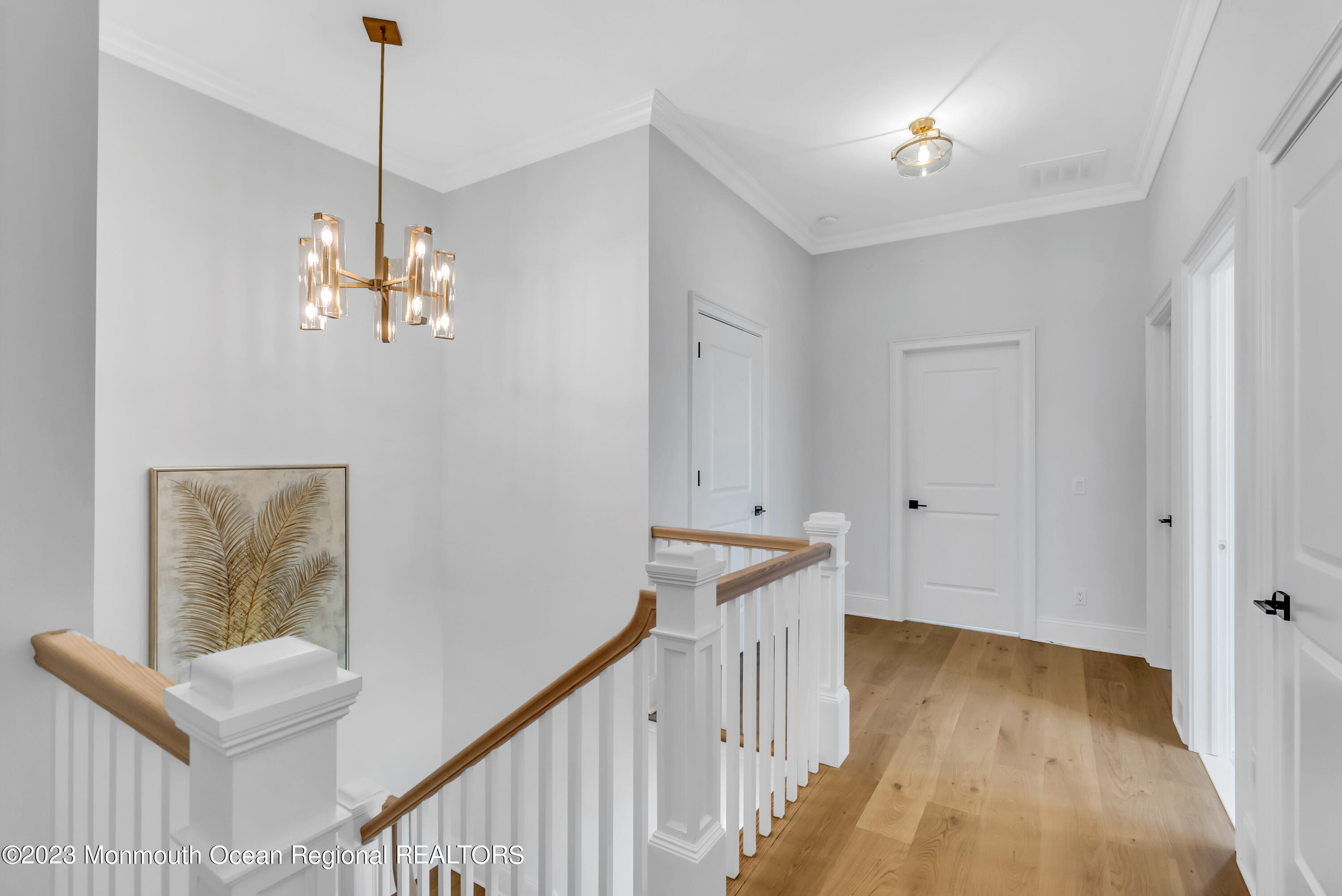 176 Eagle Way Eatontown, NJ 07724 - Photo 23 of 102 a view of a hallway to room with wooden floor and stairs
