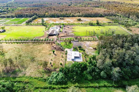 an aerial view of residential houses with outdoor space and river