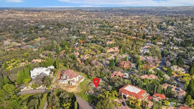 an aerial view of house with yard and mountain view in back
