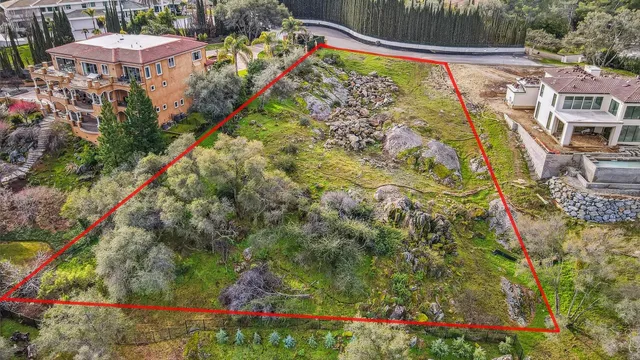 a view of a house with a chairs and table in a patio