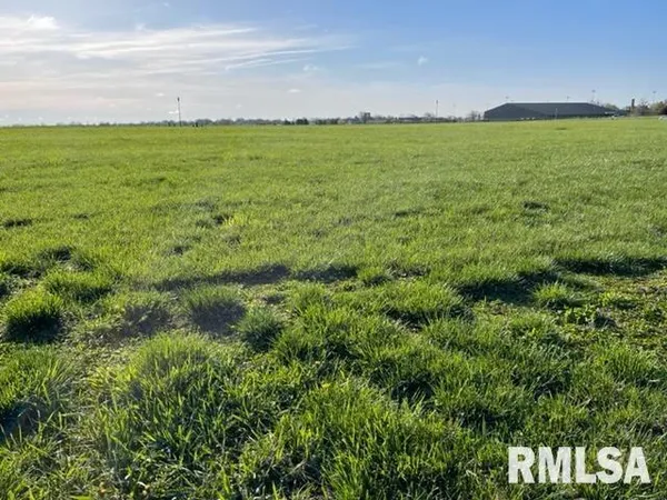 a view of a field with an ocean view