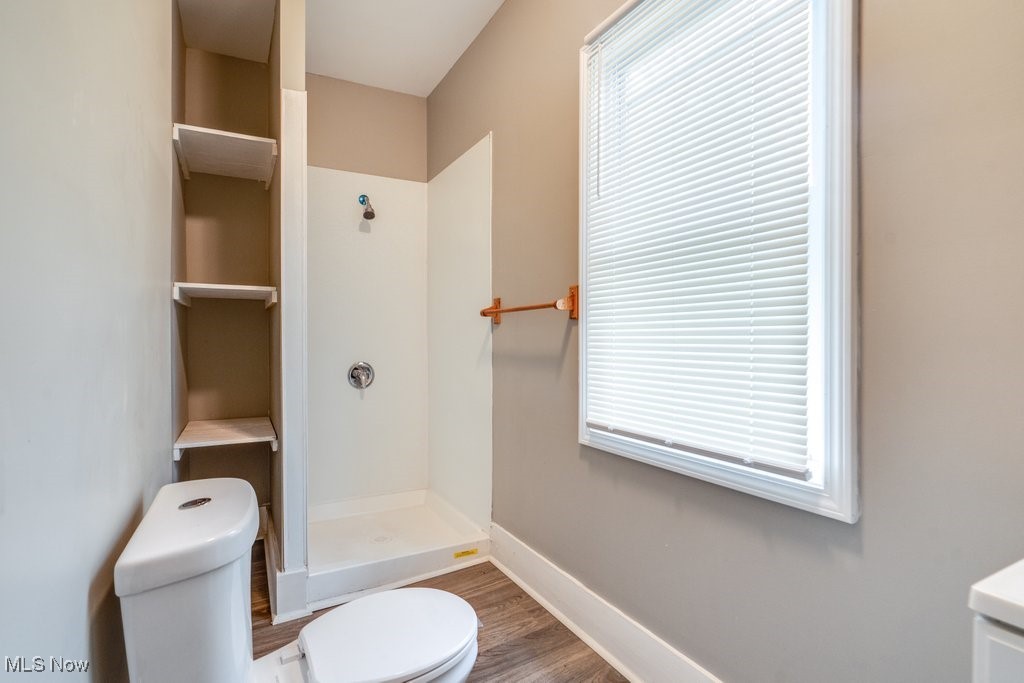 1261 Rozelle Avenue Cleveland, OH 44112 - Photo 12 of 32 Bathroom with walk in shower, toilet, hardwood / wood-style floors, and a wealth of natural light