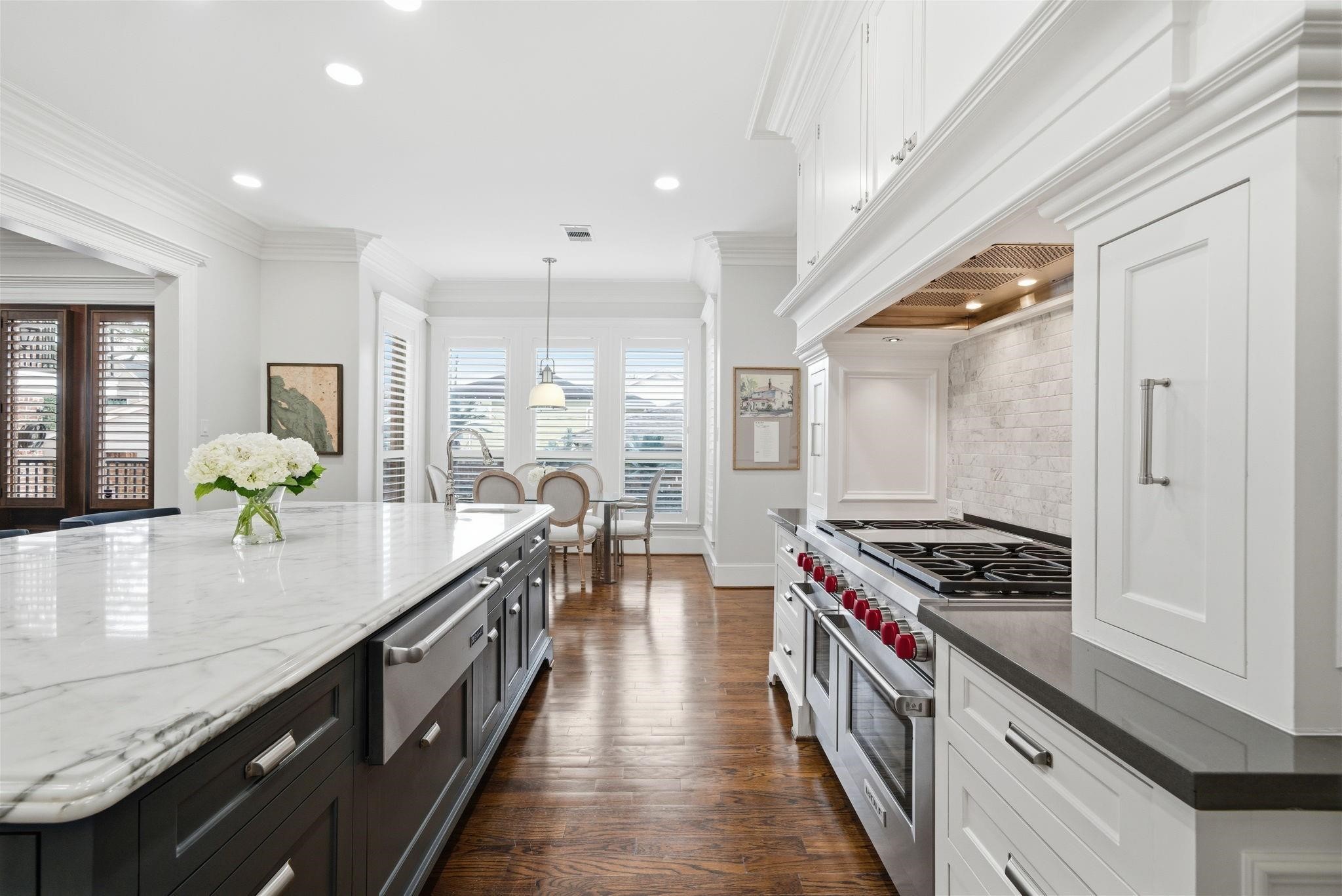 1418 Columbia Street Houston, TX 77008 - Photo 13 of 45 The Wolf gas range with 6 burners, griddle and double ovens is flanked by pull-out spice drawers, while the marble island includes a warming drawer, and prep sink with disposal to streamline meal preparation.