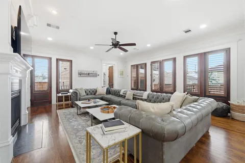 a living room with furniture gym equipment and a wooden floor