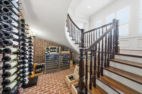 a spacious bedroom with a bed and a chandelier