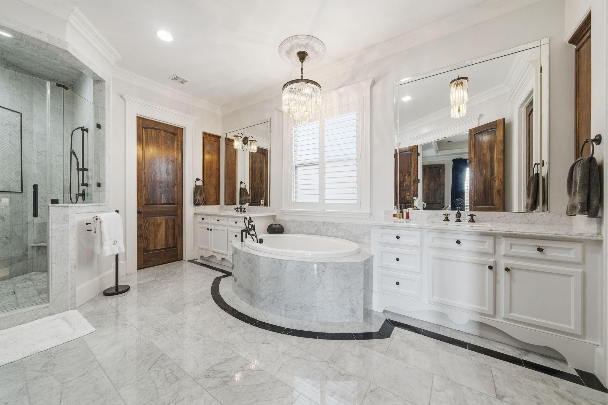 1418 Columbia Street Houston, TX 77008 - Photo 22 of 45 Remodeled in 2021, the primary bath offers a refined and serene retreat with marble flooring, freestanding soaking tub, generous dual vanities, walk-in shower, and separate walk in closets.