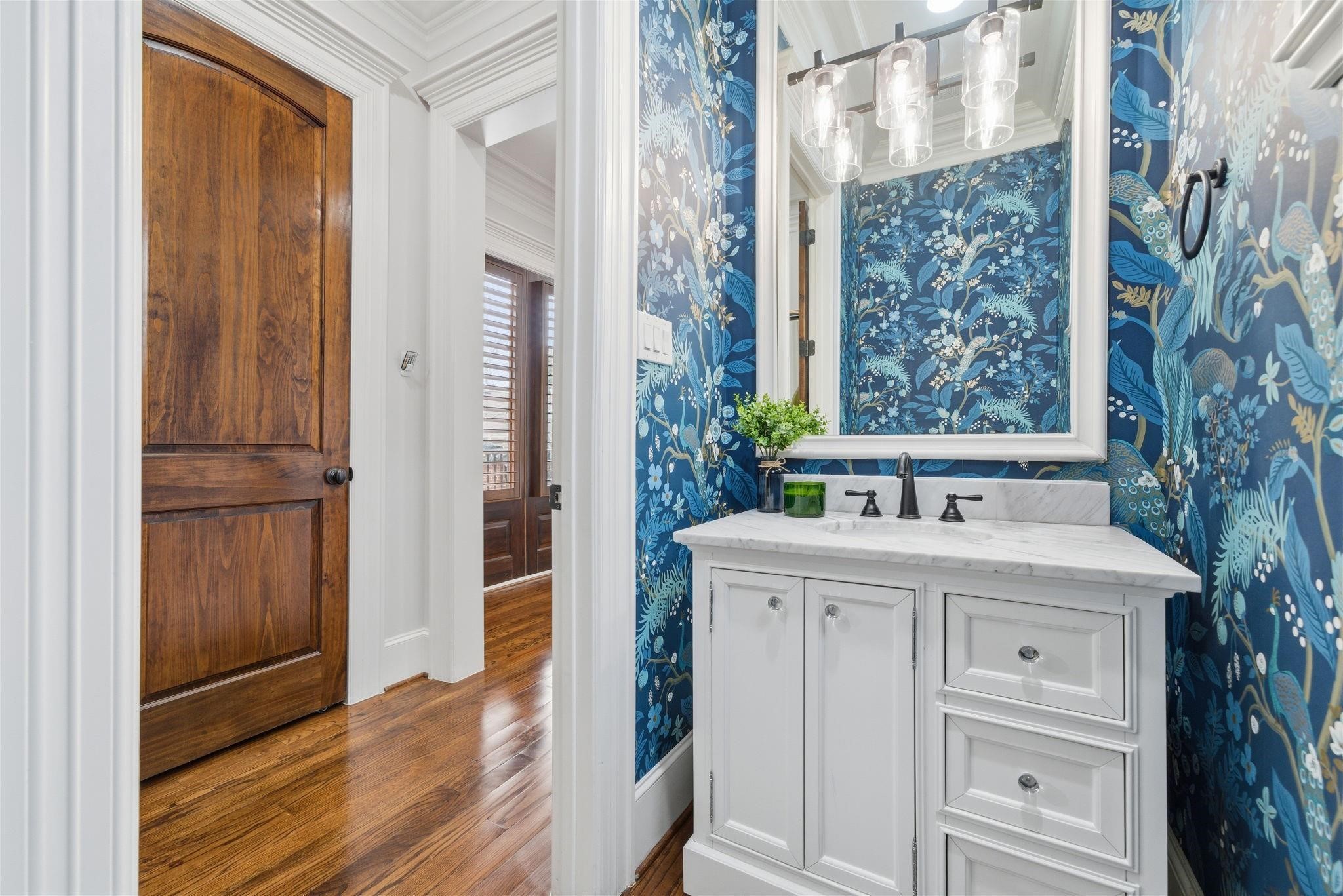 1418 Columbia Street Houston, TX 77008 - Photo 38 of 45 The updated main floor powder bath features bold designer wallpaper, a marble countertop, and classic finishes, delivering an unexpected pop of personality.