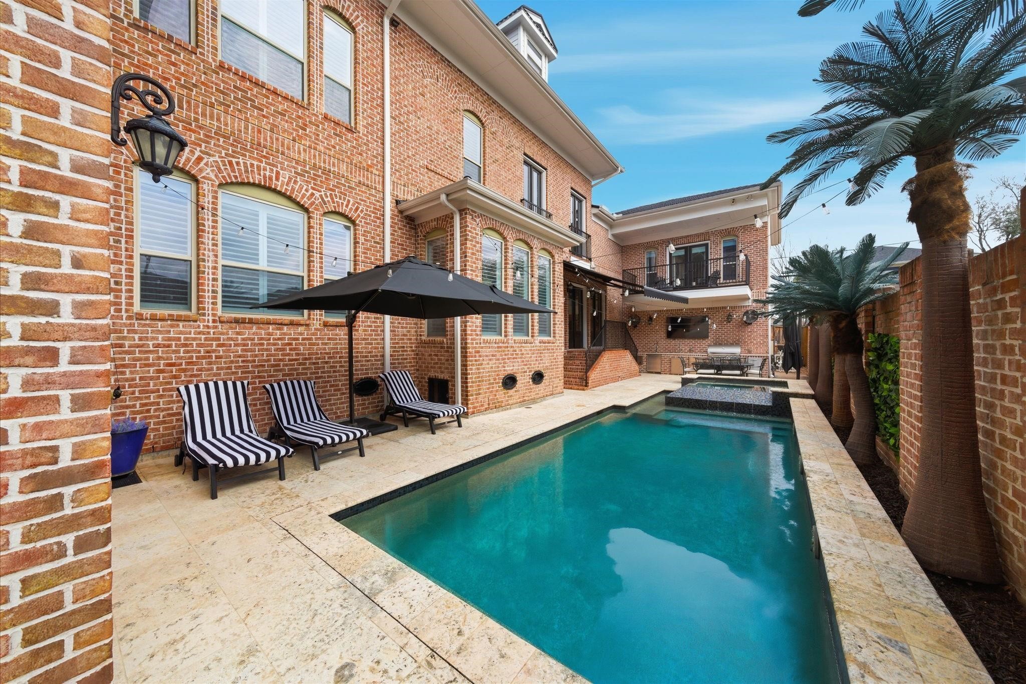 1418 Columbia Street Houston, TX 77008 - Photo 40 of 45 Classic brick exterior paired with a fully equipped summer kitchen and electric awning, creating a comfortable, shaded space to relax poolside or host with ease.