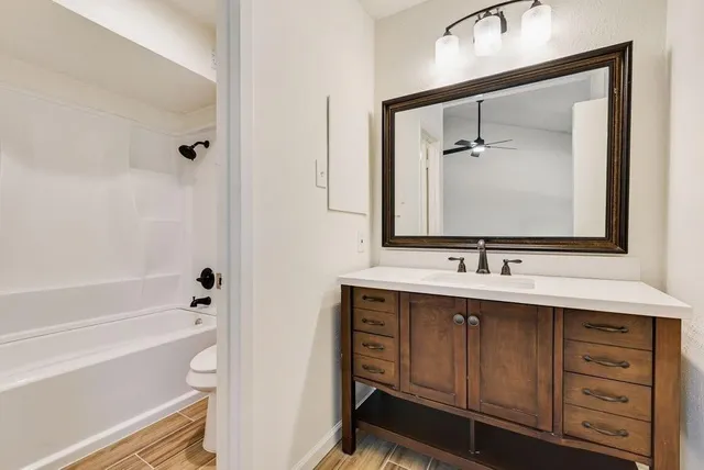 a bathroom with a tub sink and mirror