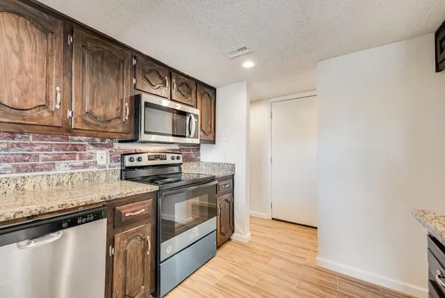 a kitchen with a stove microwave and sink