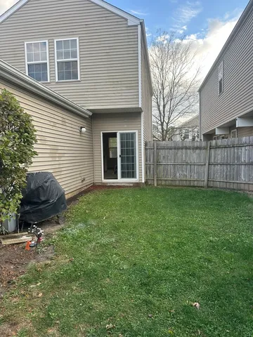 a backyard of a house with a garden and barbeque oven