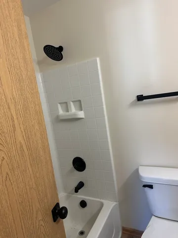 a bathroom with a granite countertop sink toilet and a mirror