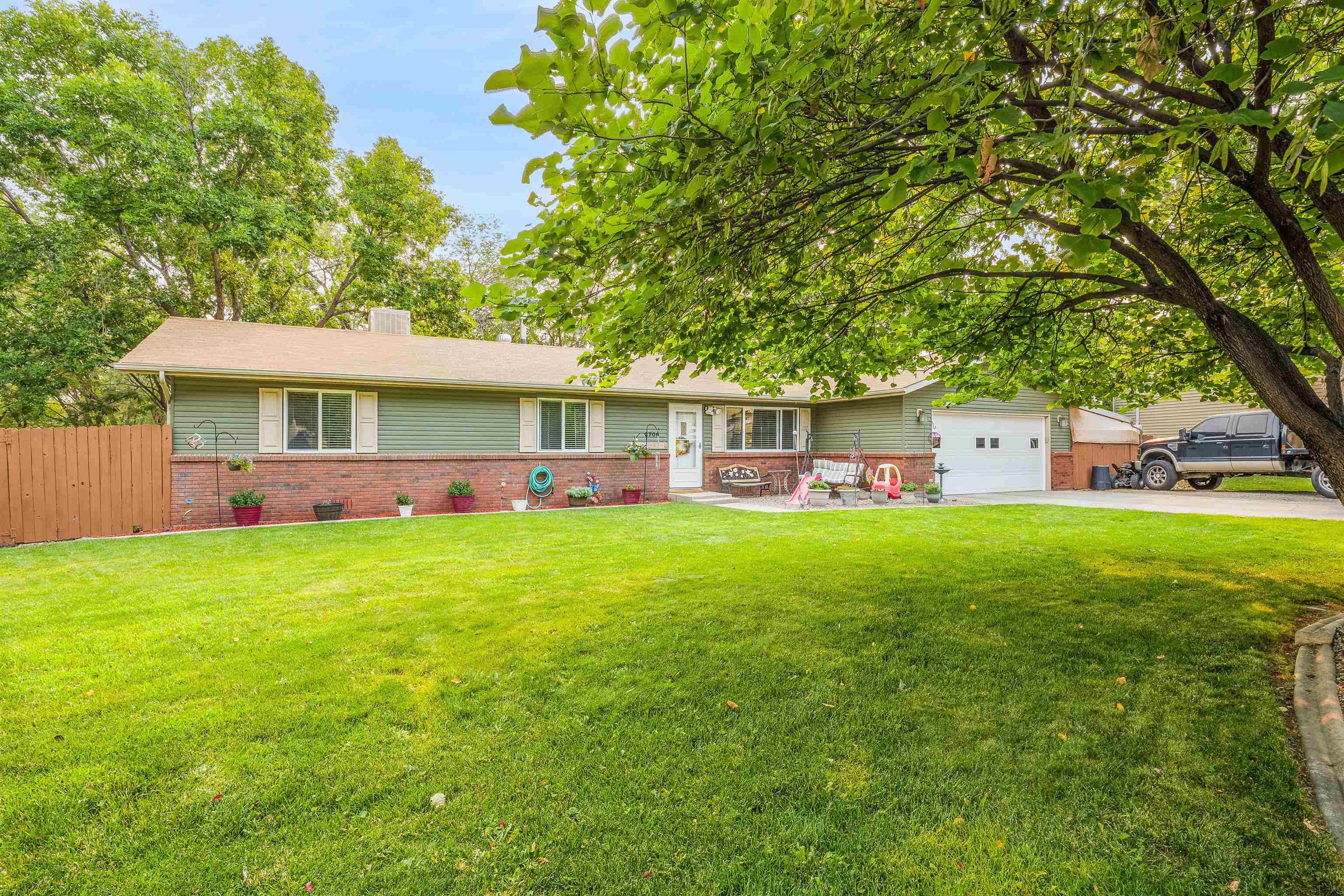 a view of a house with a backyard
