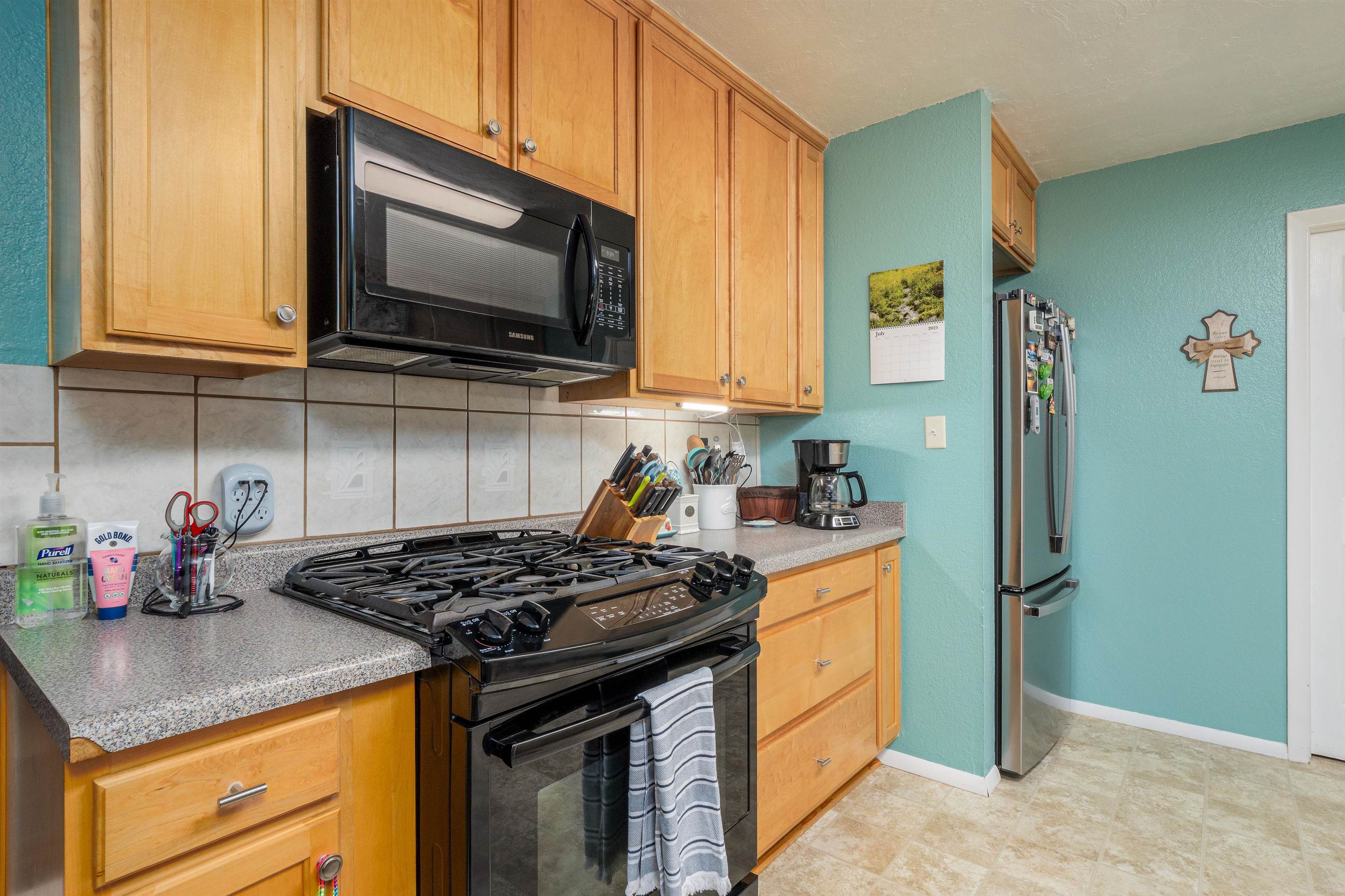 2706 Rincon Drive Grand Junction, CO 81503 - Photo 16 of 42 a kitchen with stainless steel appliances granite countertop a stove and a microwave