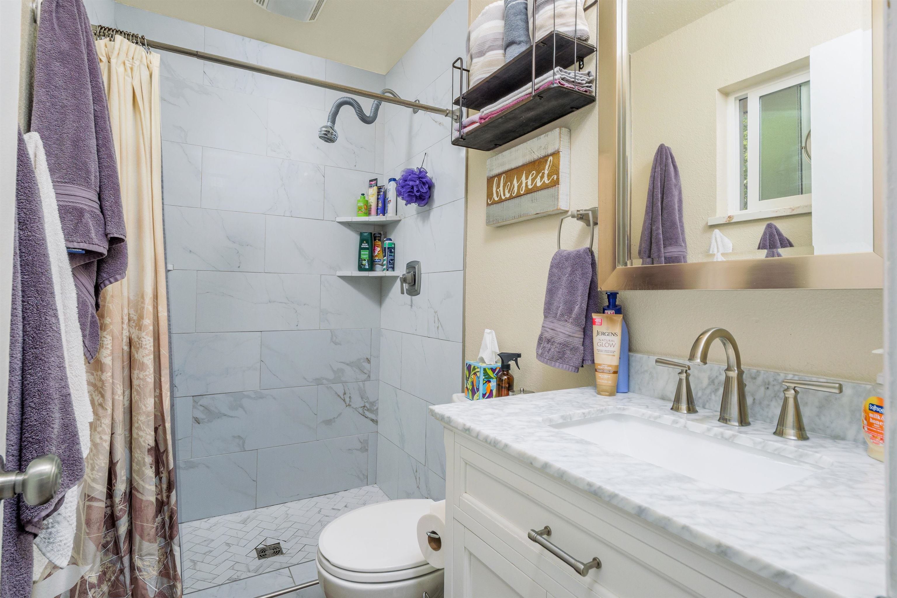 2706 Rincon Drive Grand Junction, CO 81503 - Photo 32 of 42 a bathroom with a granite countertop sink a toilet and shower
