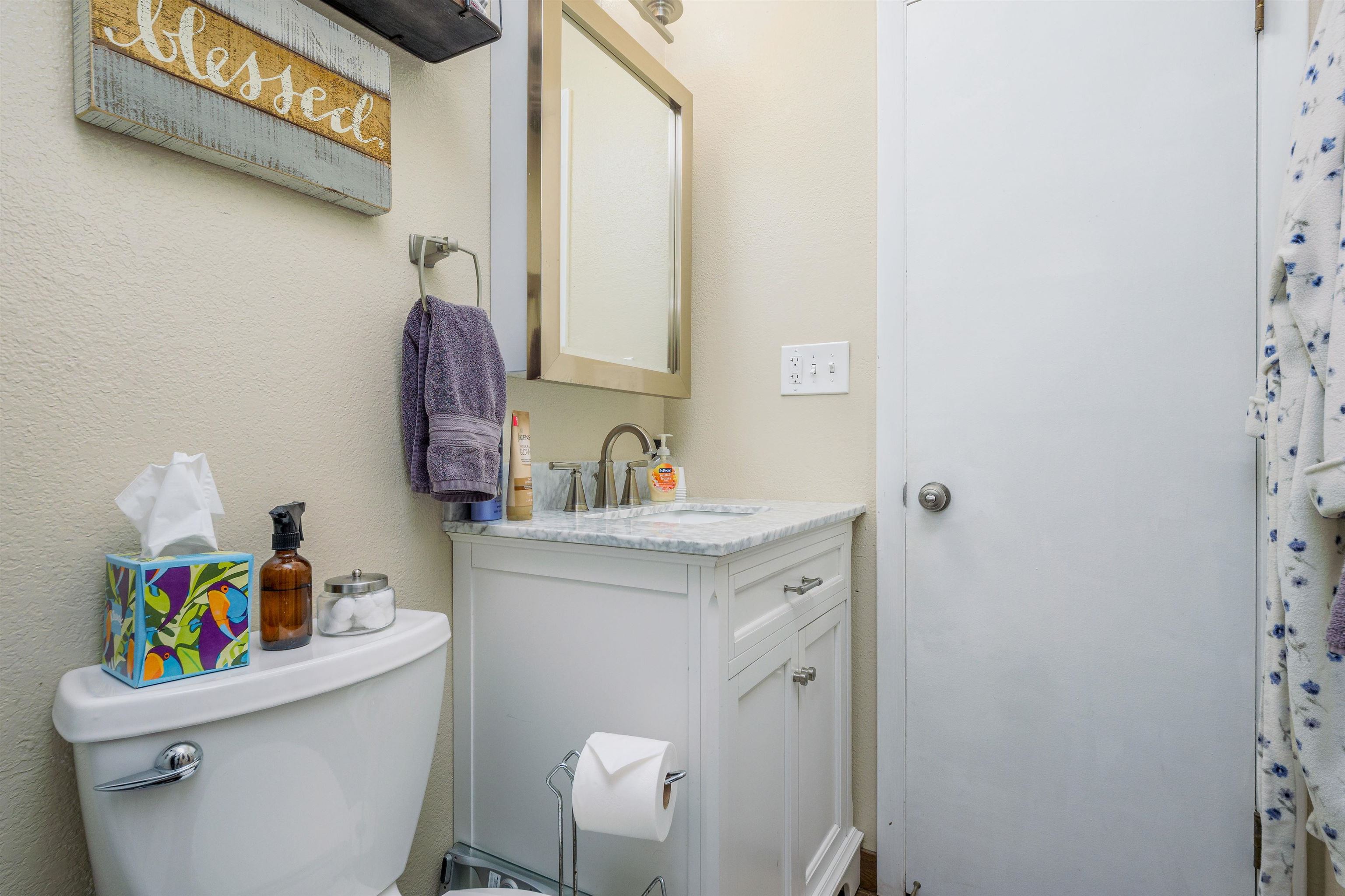 2706 Rincon Drive Grand Junction, CO 81503 - Photo 33 of 42 a bathroom with a sink vanity mirror and toilet