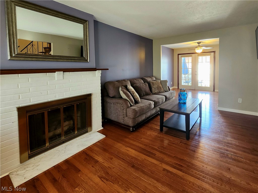 6488 State Road, Unit B 12 Cleveland, OH 44134 - Photo 8 of 46 Living room featuring ceiling fan, a brick fireplace, and dark wood-type flooring