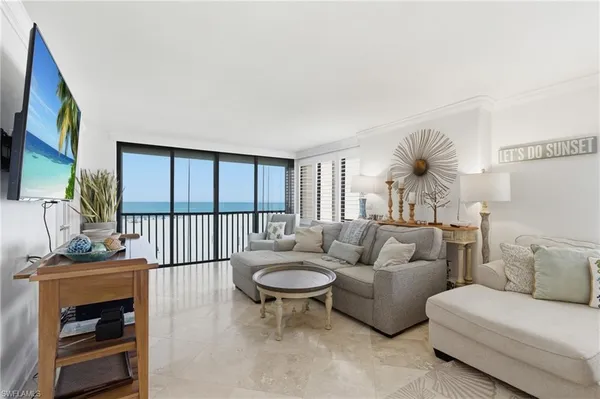 a living room with furniture a fireplace and a large window