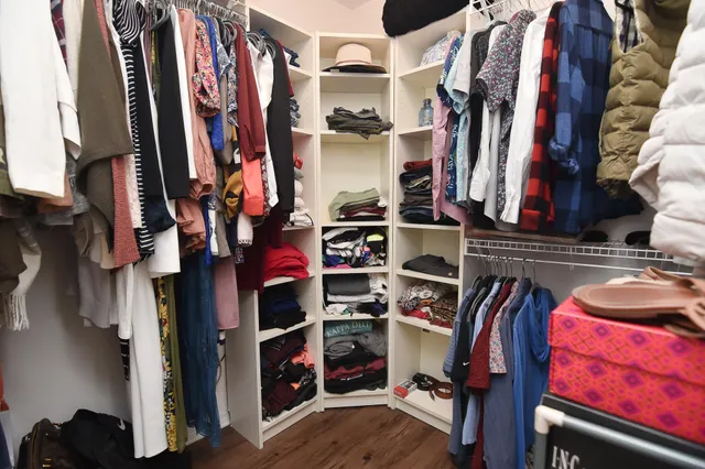 a view of walk in closet with clothes and shoes