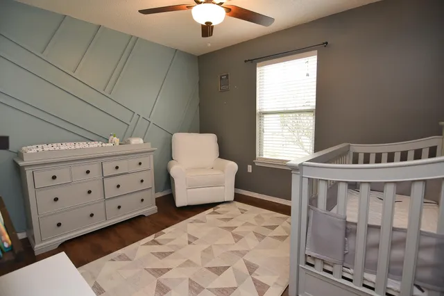 a bedroom with furniture and a window