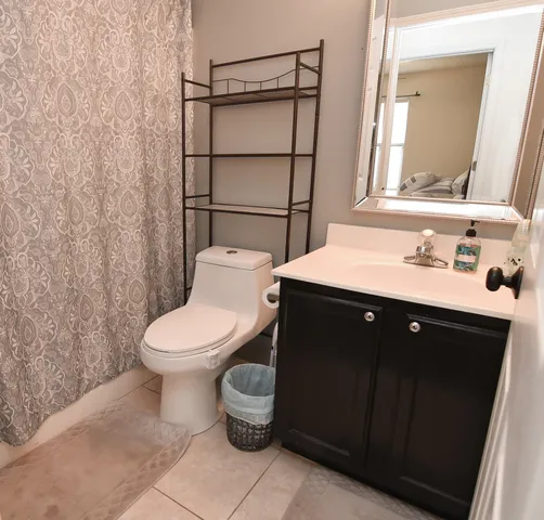 a bathroom with a toilet a sink and mirror