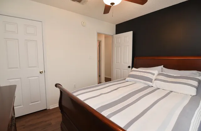 a bedroom with a bed and a chandelier