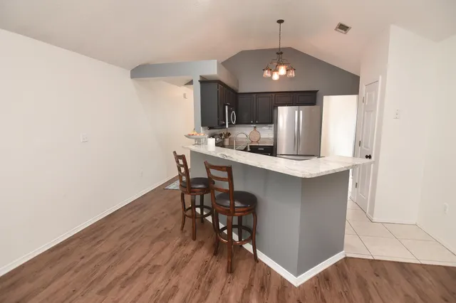 a kitchen with a table and chairs in it