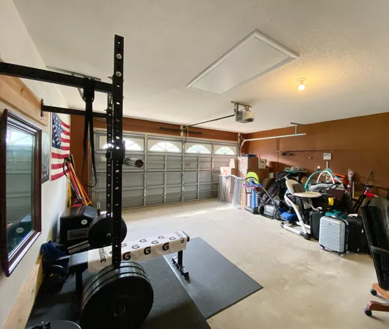 a room with gym equipment and a large window
