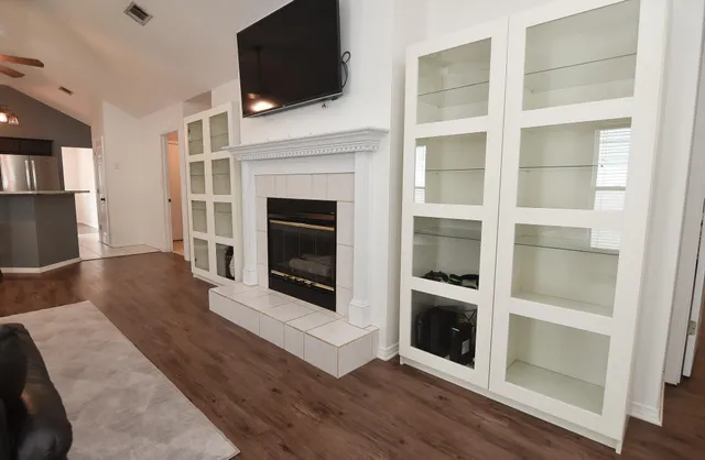 a living room with a fireplace and a flat screen tv