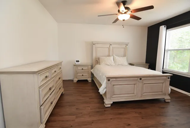 a room with a bed and a chandelier