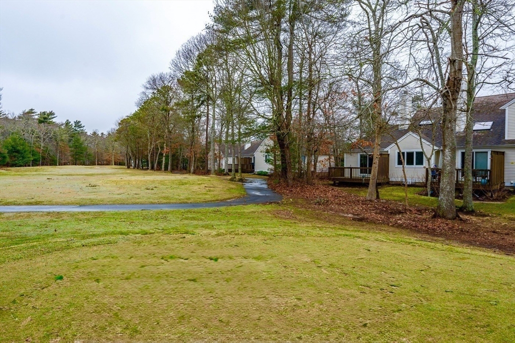 13 Pga Lane, Unit 424 Mashpee, MA 02649 - Photo 16 of 19 a view of a playground with a house
