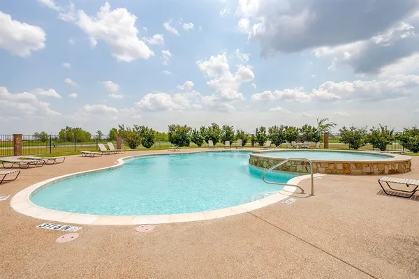a view of a swimming pool with a yard
