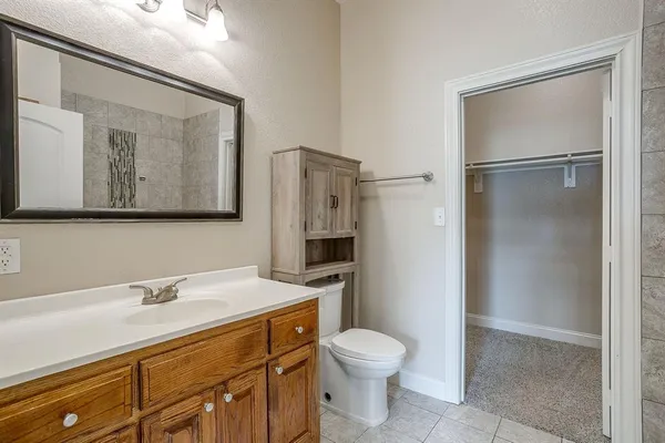 a bathroom with a toilet sink and shower